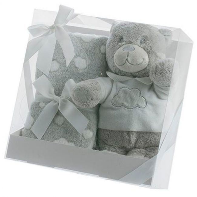 Teddybär-Puppe und graue Decke