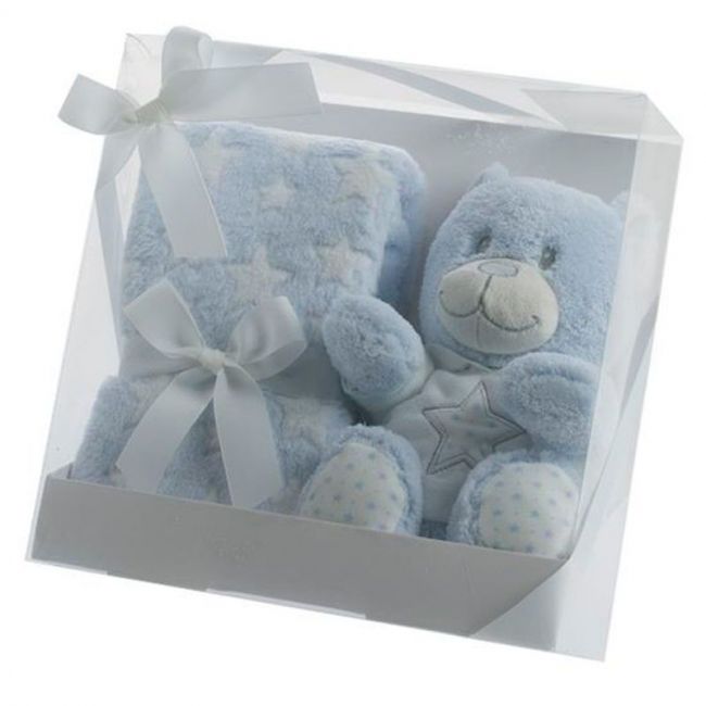 Teddybär-Puppe und blaue Decke